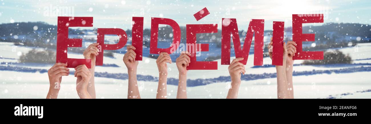 People Hands Holding Word Epidemie Means Epidemic, Snowy Winter Background Stock Photo