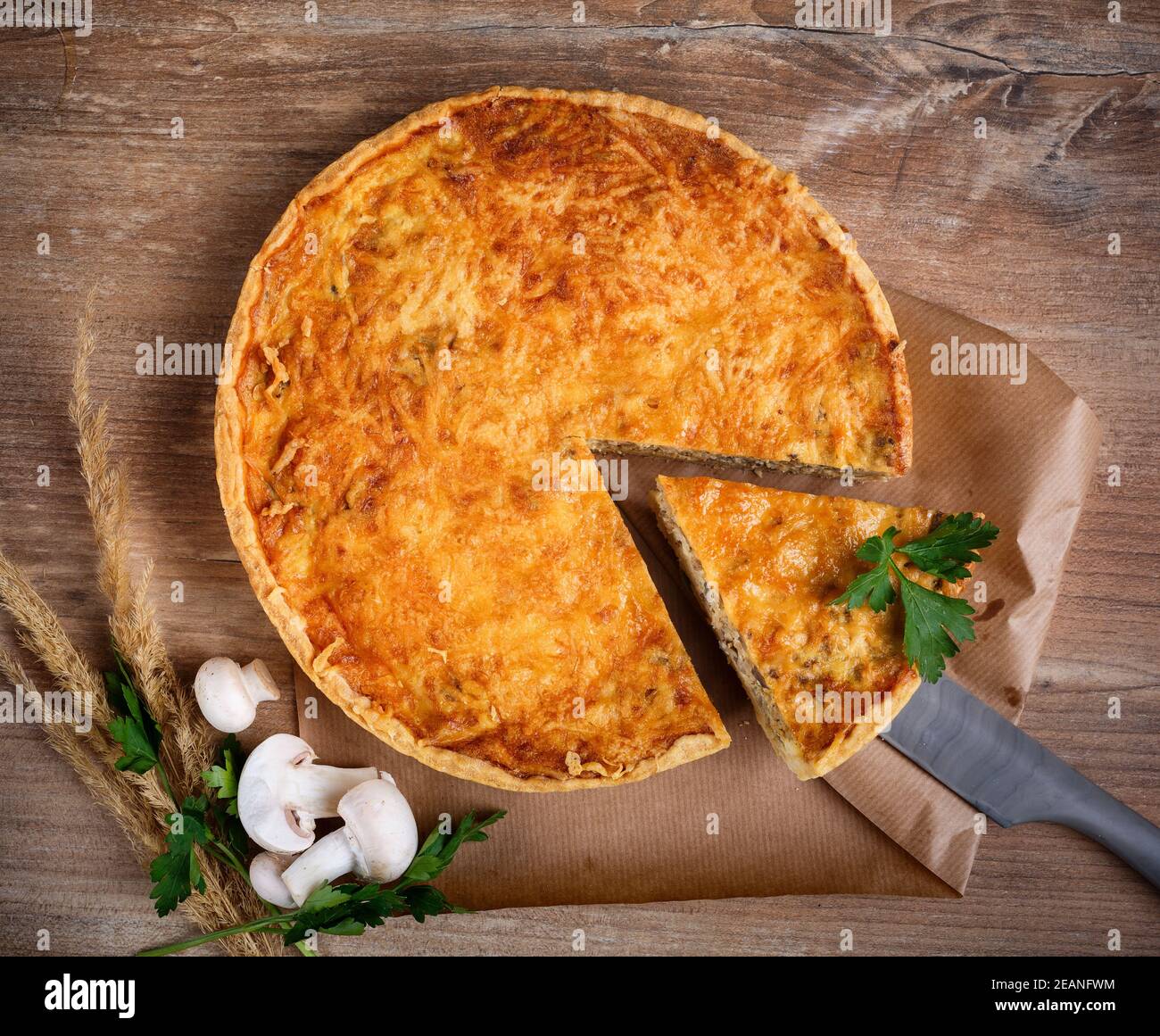 Homemade tart with puff pastry with mushrooms, cheese, onion, parsley