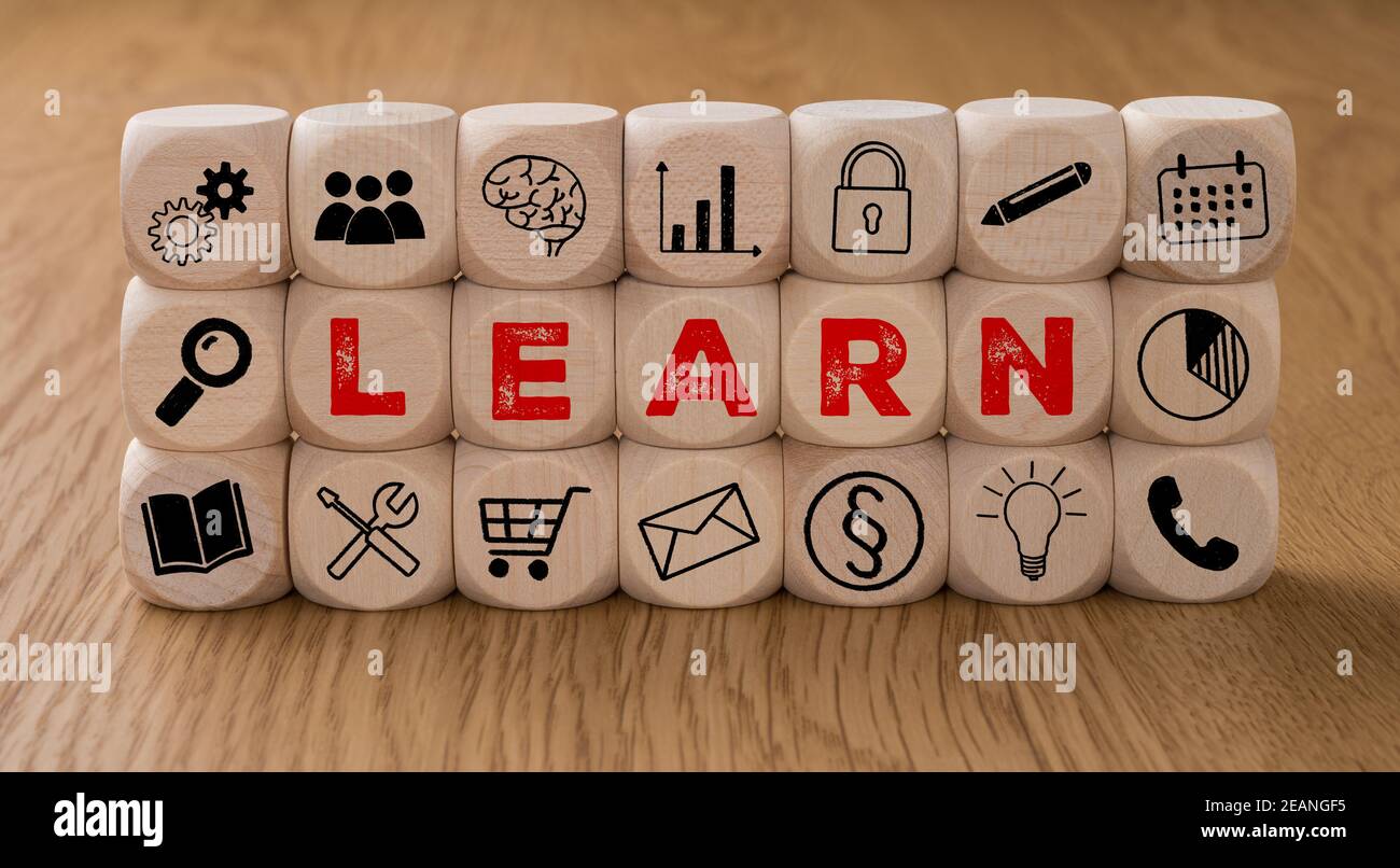 Dice with icons and the word Learn Stock Photo - Alamy