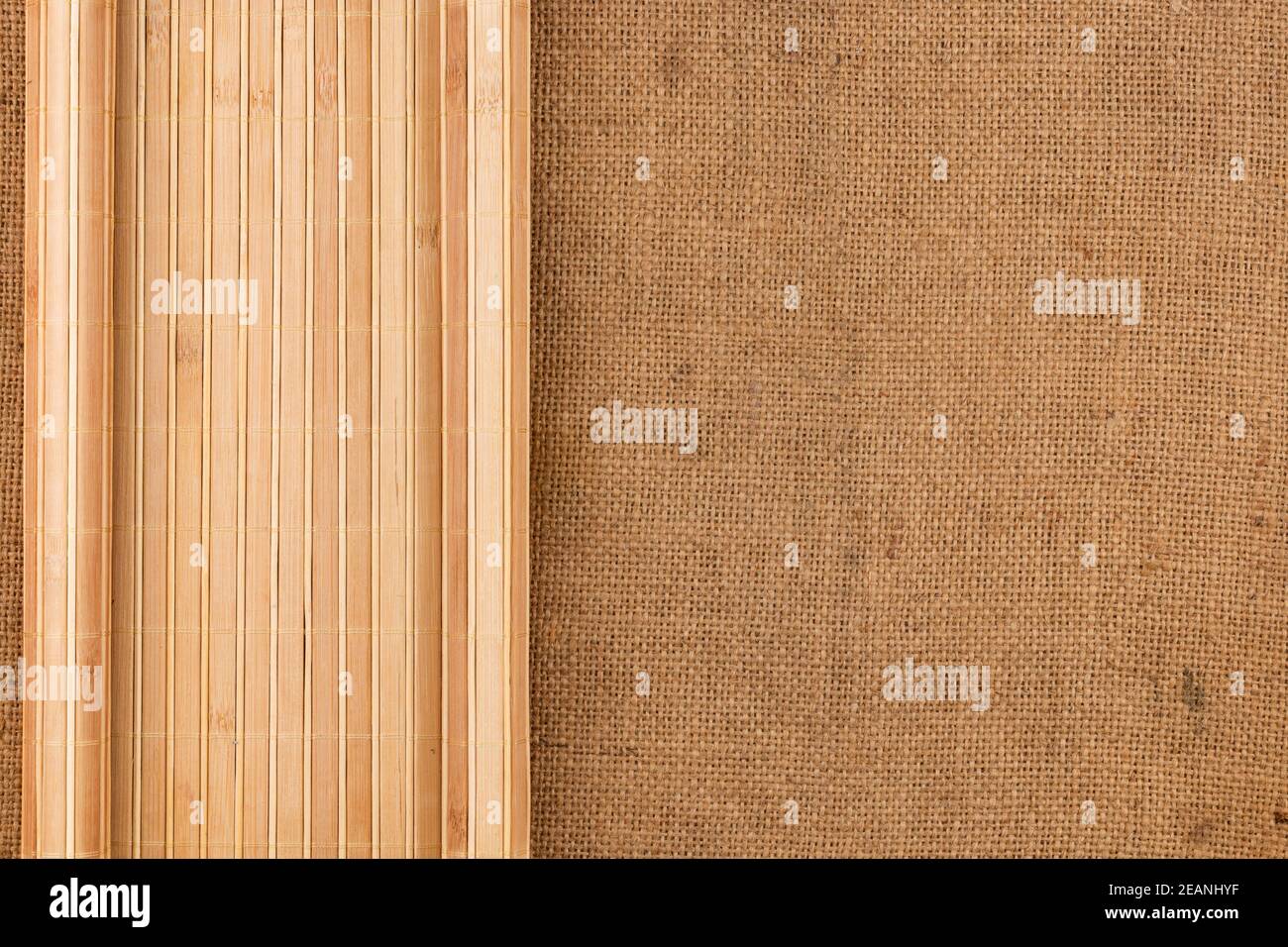 Bamboo mat twisted in the form of a manuscript on sackcloth Stock Photo