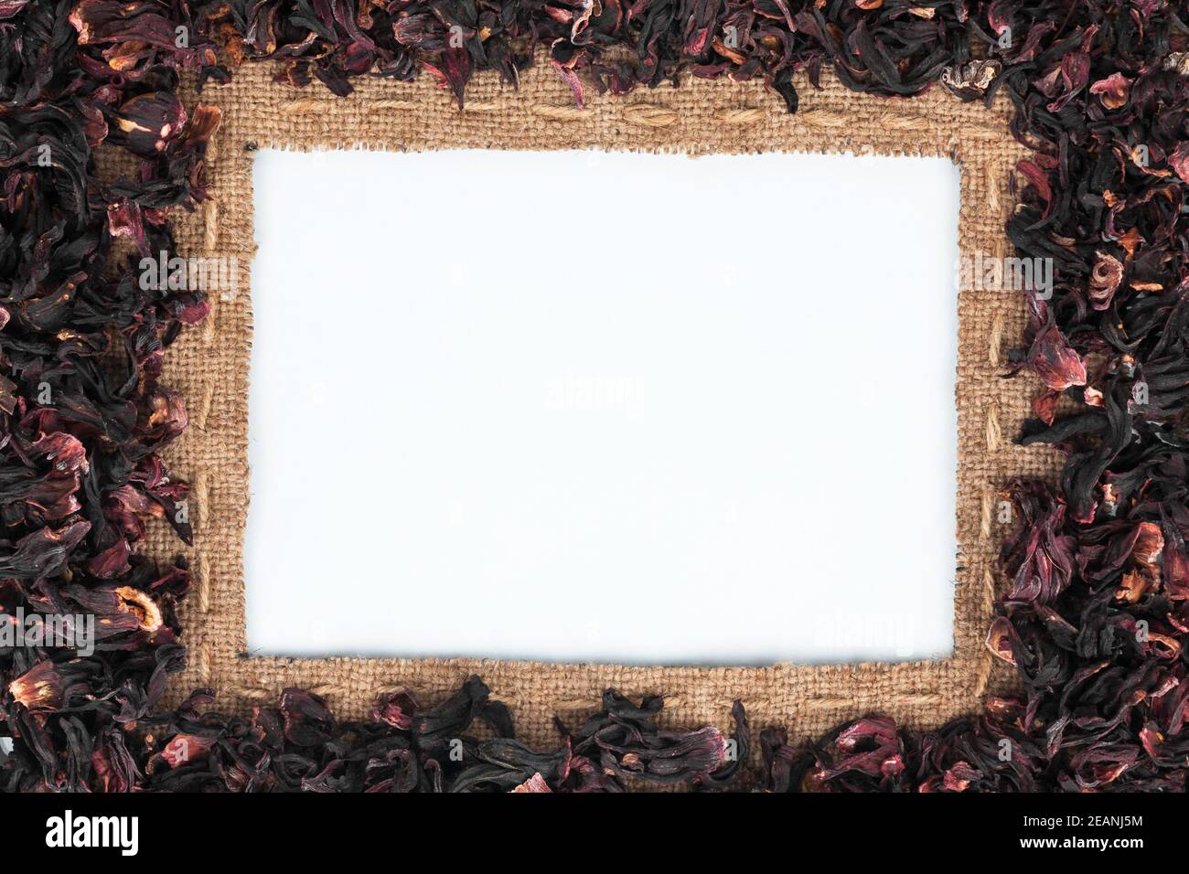 Frame made of burlap with the line and hibiscus lies on white