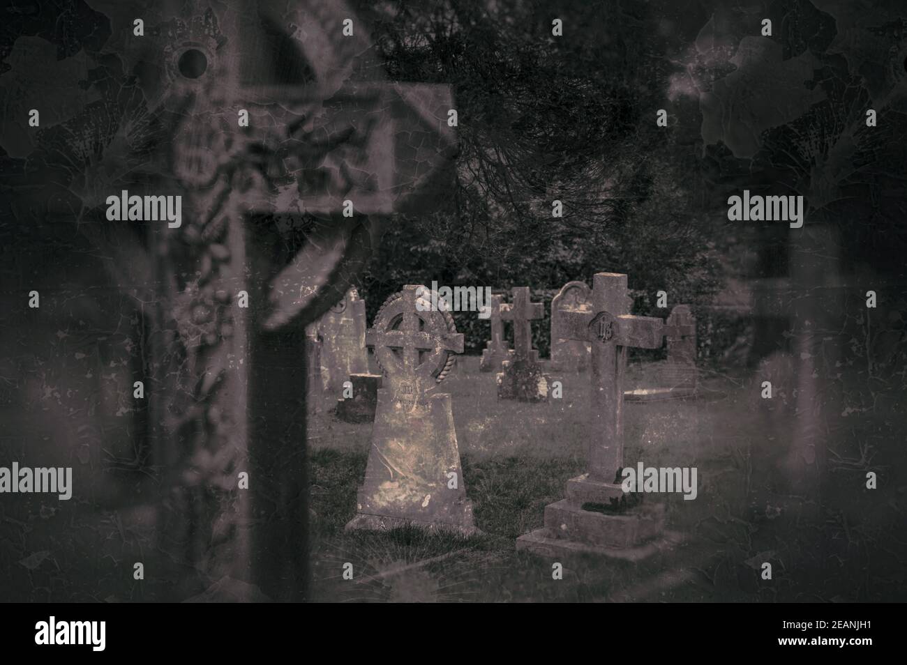 Spooky grunge effect image of graveyard with graves and gravestones. Stock Photo