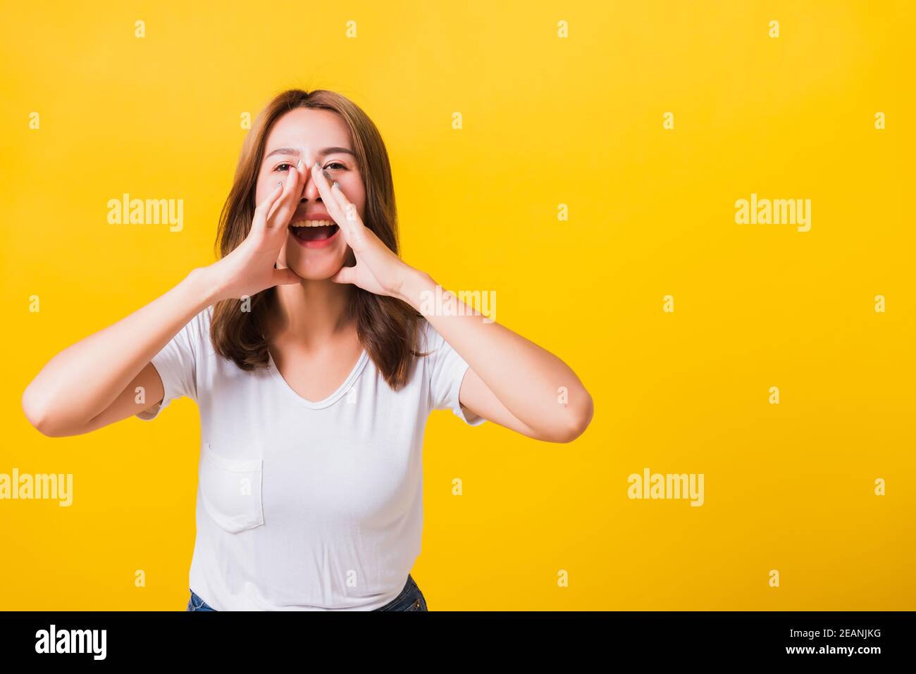 woman teen standing big shout out with hands next mouth giving excited positive Stock Photo