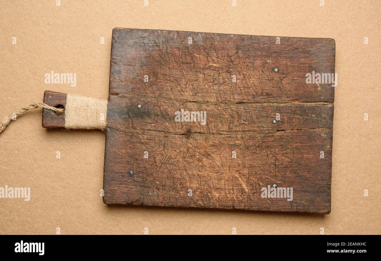 empty old brown rectangular wooden cutting board, brown background Stock Photo