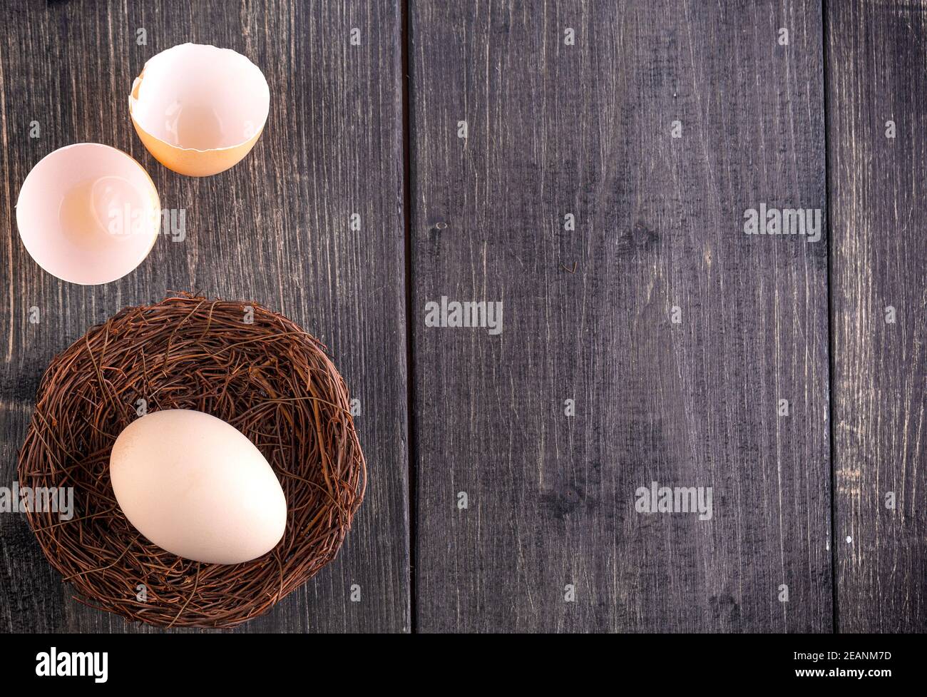 The white egg on the nest on the old wooden background Stock Photo