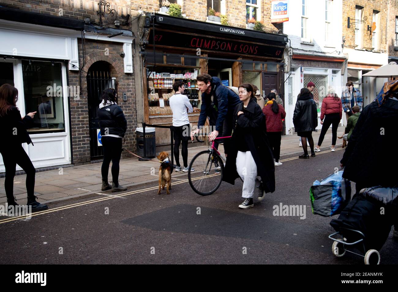 February in Hackney. Broadway market. Young people queue to buy coffee at Climpsons. Stock Photo
