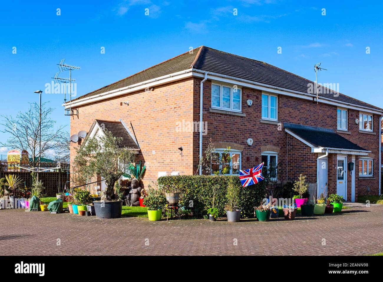Lots of potted plants on patio with Union Jack in Elworth near Sandbach Cheshire UK Stock Photo