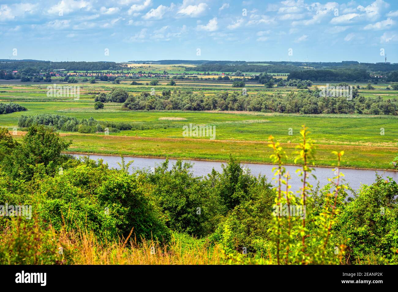 Summer rural landscape with a river, forest and an agriculture field Stock Photo