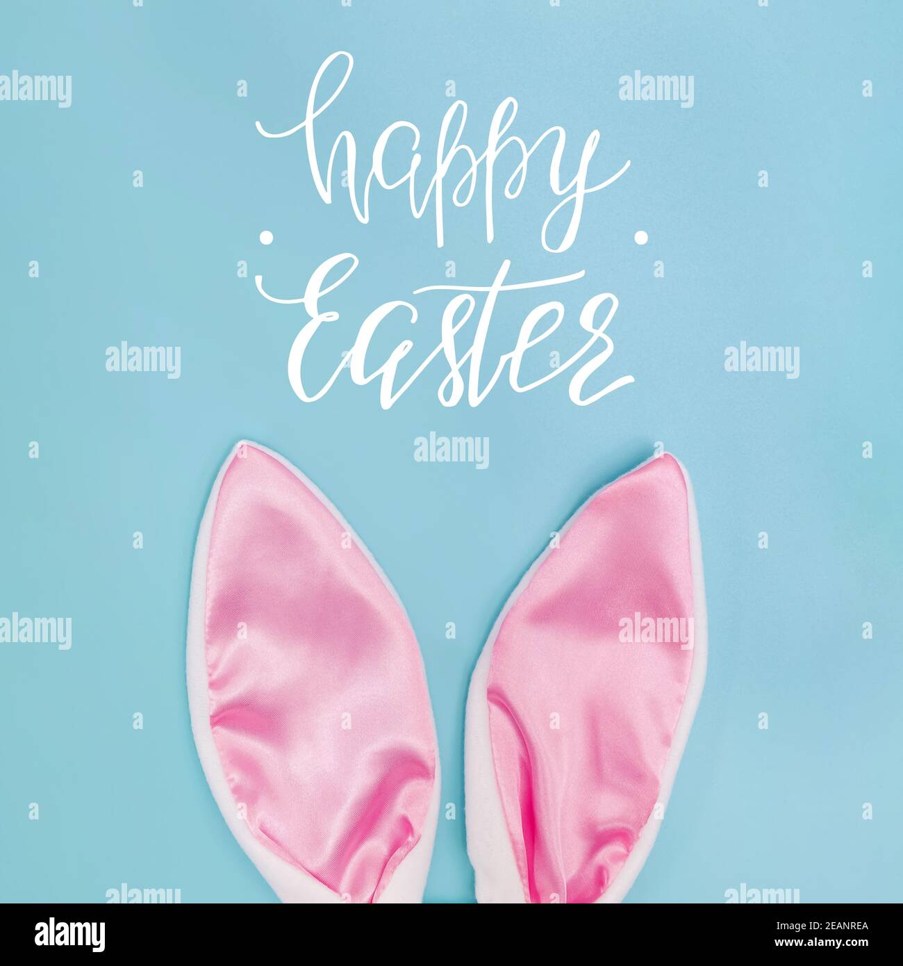 Decorative pink bunny ears on blue background Stock Photo