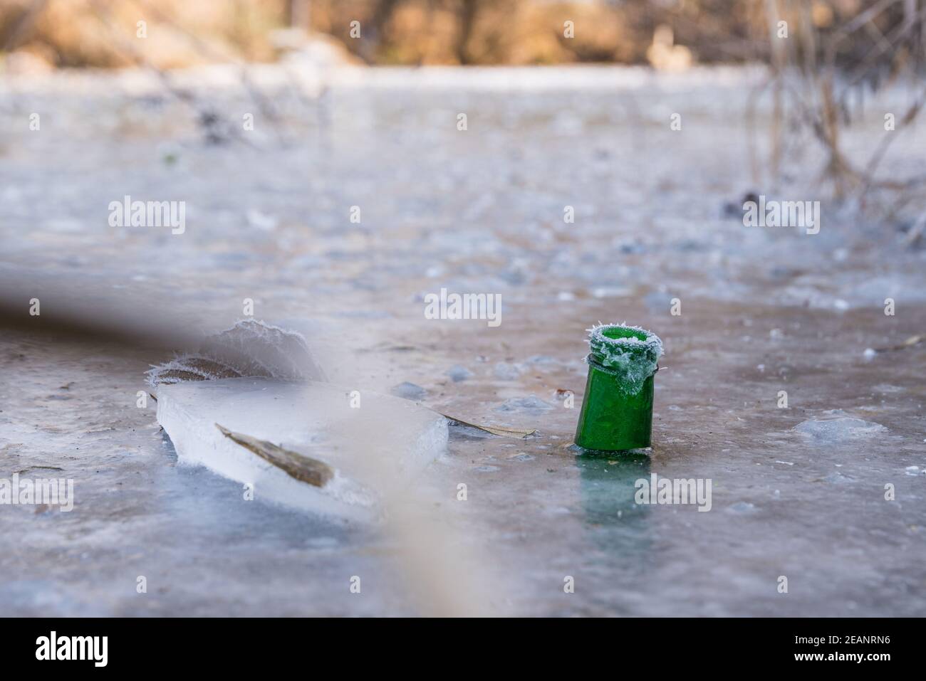 Drinking bottle frozen in ice Stock Photo