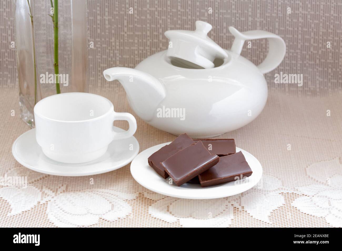 teapot, cup and chocolate on a plate Stock Photo