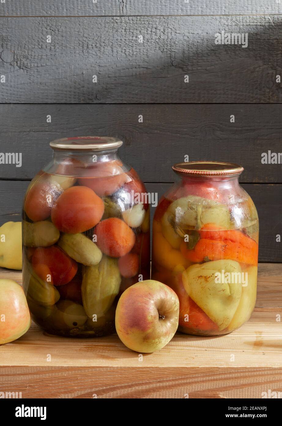 Canned vegetables in glass jars on a shelf in the basement Stock Photo