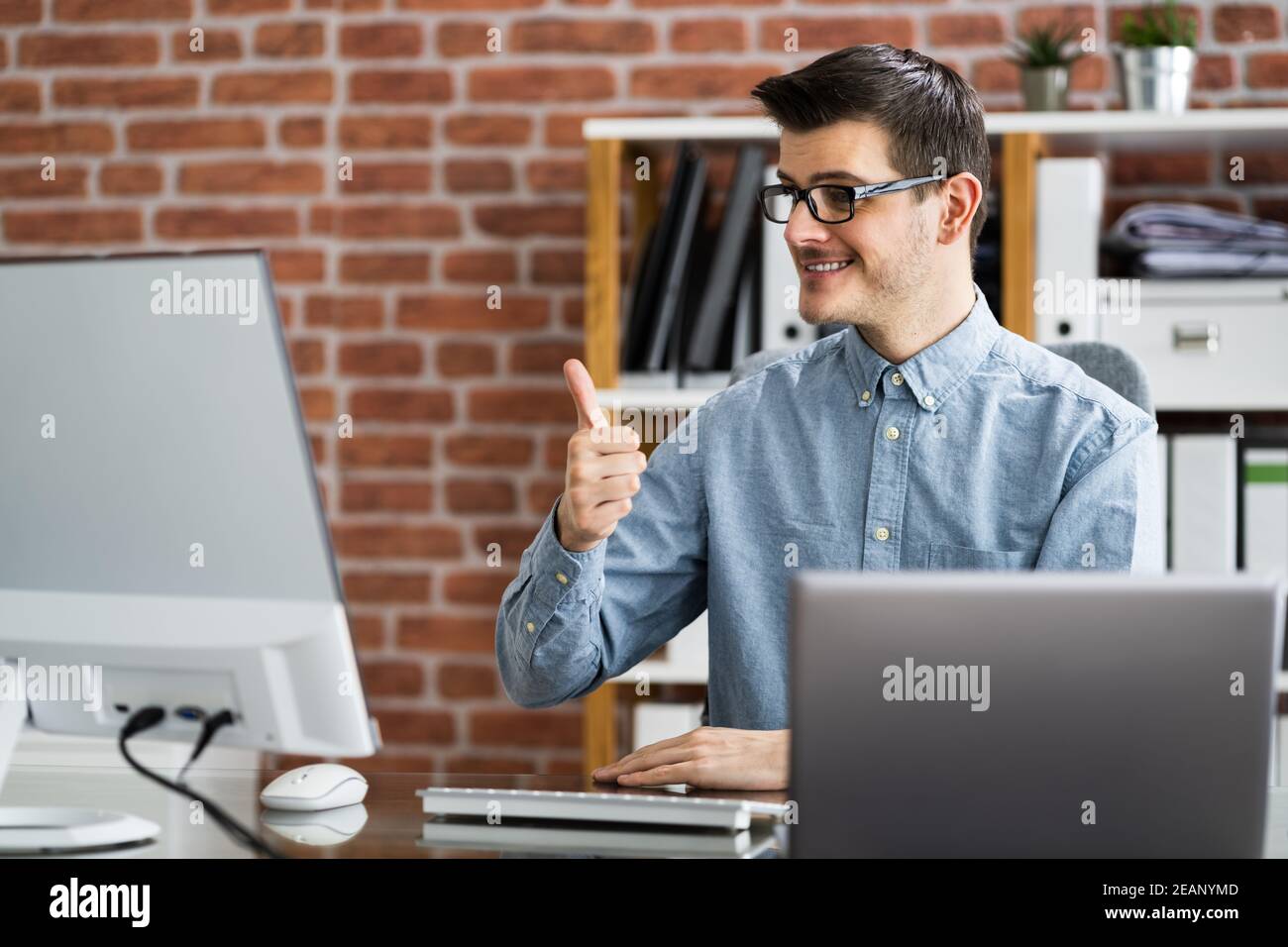 Happy Man Showing Thumbs Up In Video Conference Webinar Stock Photo