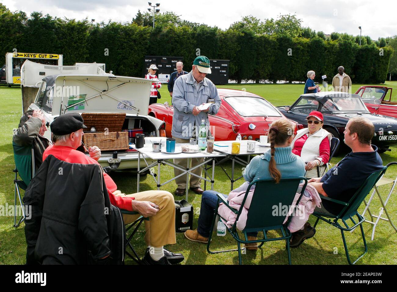 Car enthusiasts and exhibitors enjoying a picnic and cup of tea at a classic car show, UK Stock Photo