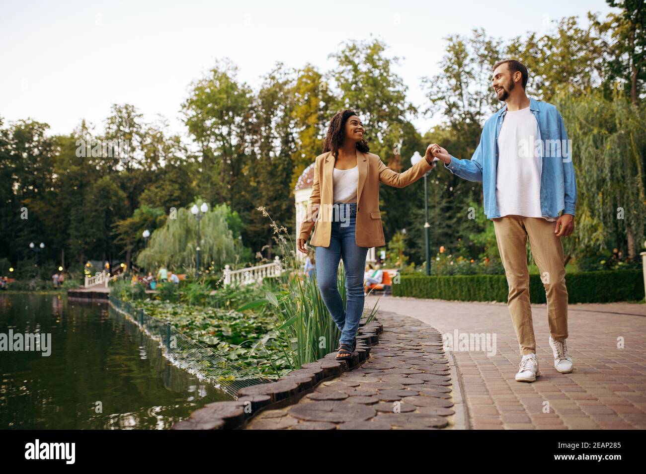Romantic love couple walking at the pond in park Stock Photo - Alamy