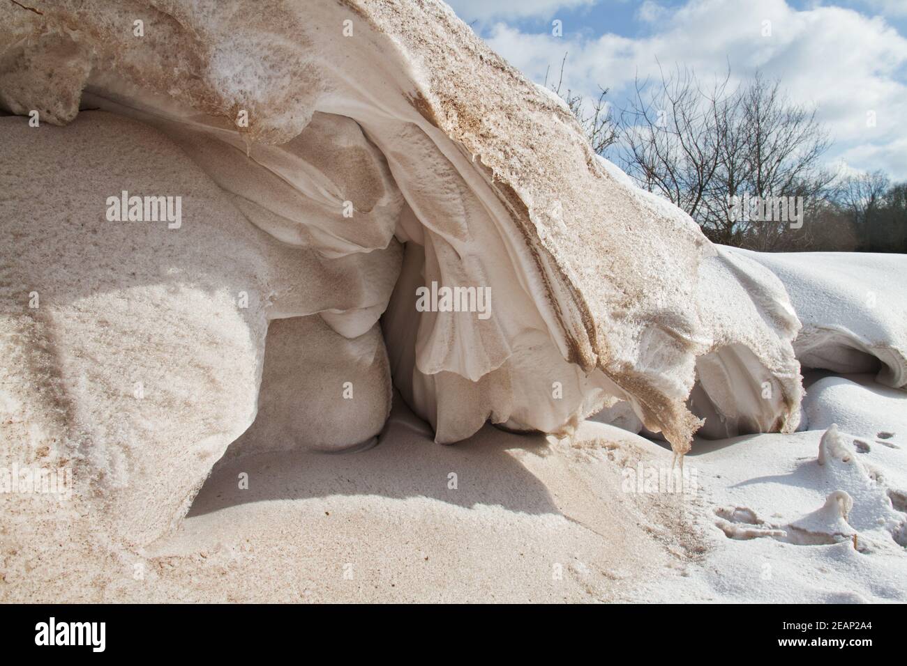 Snowdrift, a deposit of snow and some sand sculpted by wind into a mound during a snowstorm Stock Photo