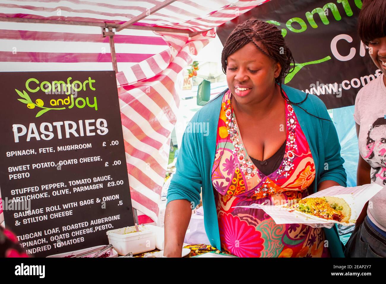 Lady serving street food at a food stall at Underground Festival in Crystal Palace,South London Stock Photo