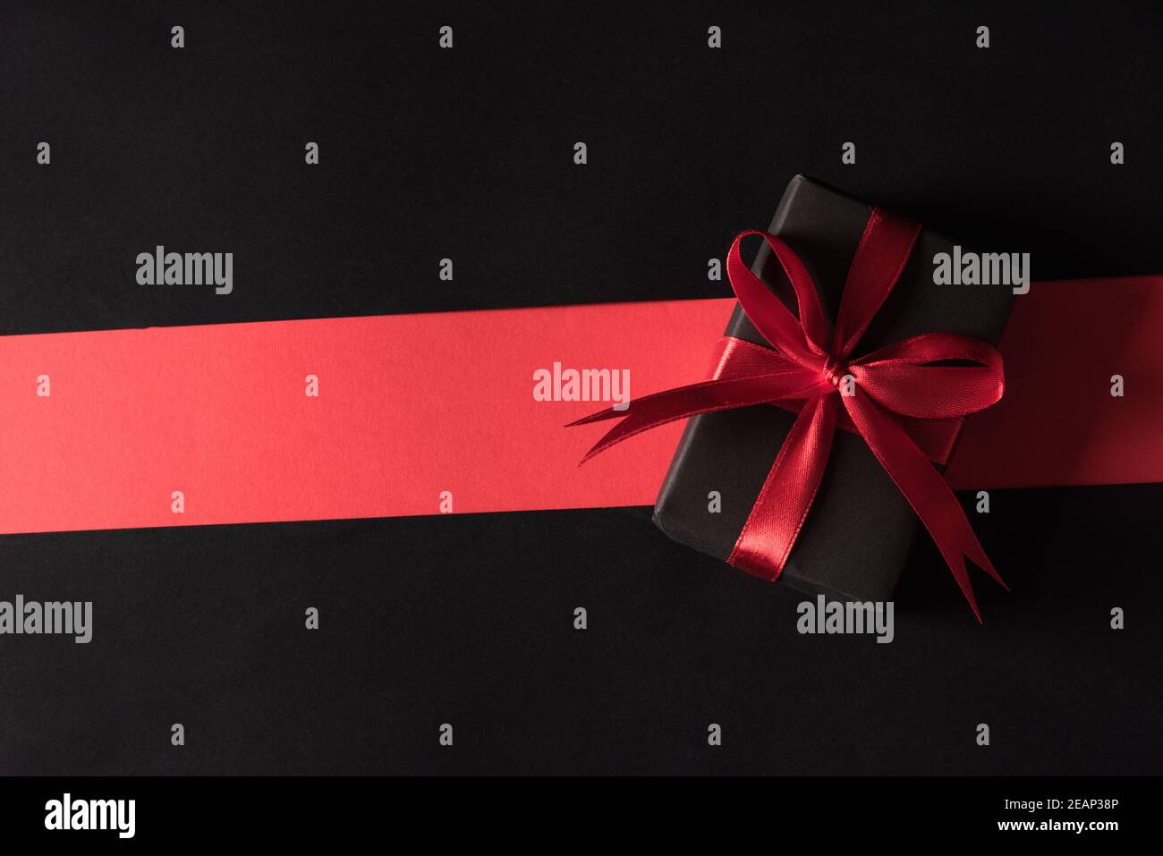 Gift box wrapped black paper and black bow ribbon present Stock Photo