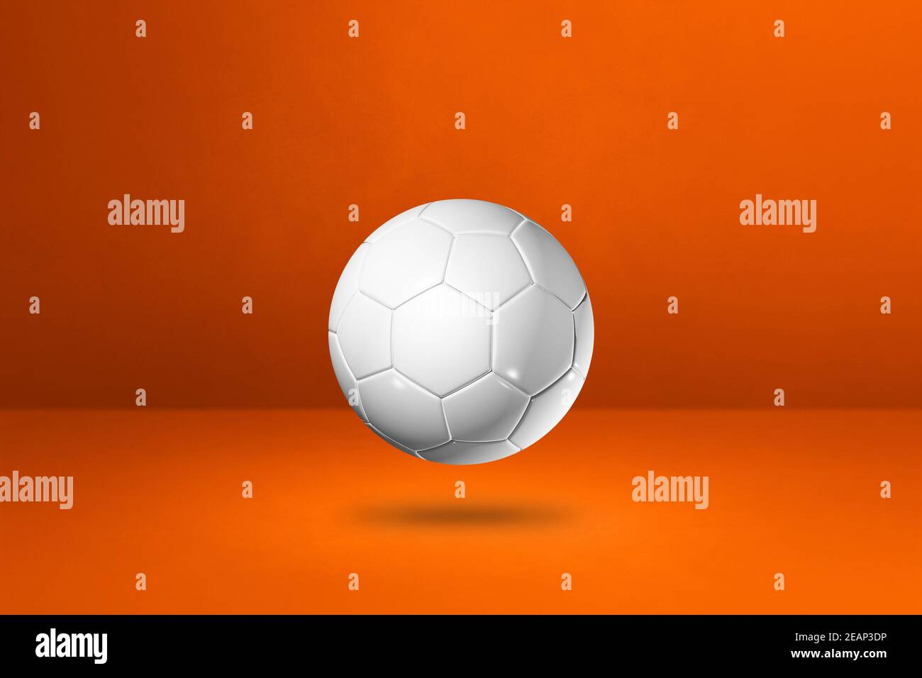 White soccer ball on a orange studio background Stock Photo