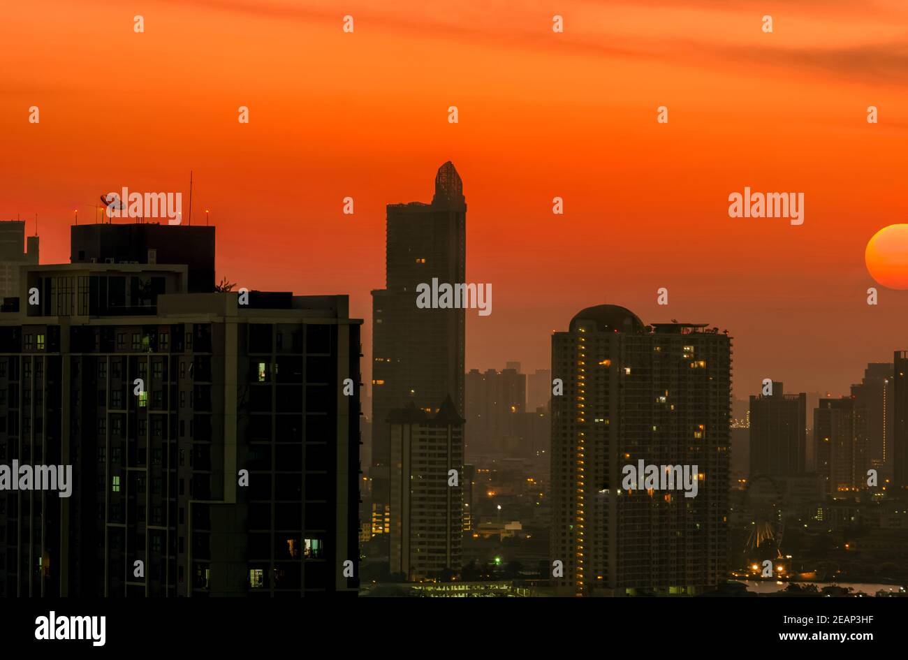 Cityscape with beautiful morning sunrise sky. Air pollution in Bangkok, Thailand. Smog and fine dust of pm2.5 covered the city. Cityscape with polluted air. Dirty environment. Urban toxic dust. Stock Photo