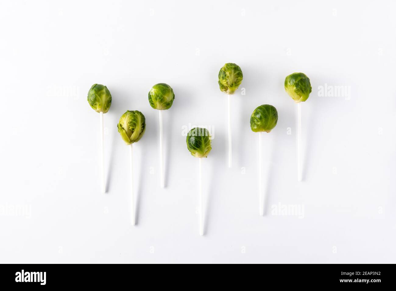 Set of brussel sprouts with lollipop sticks isolated on white