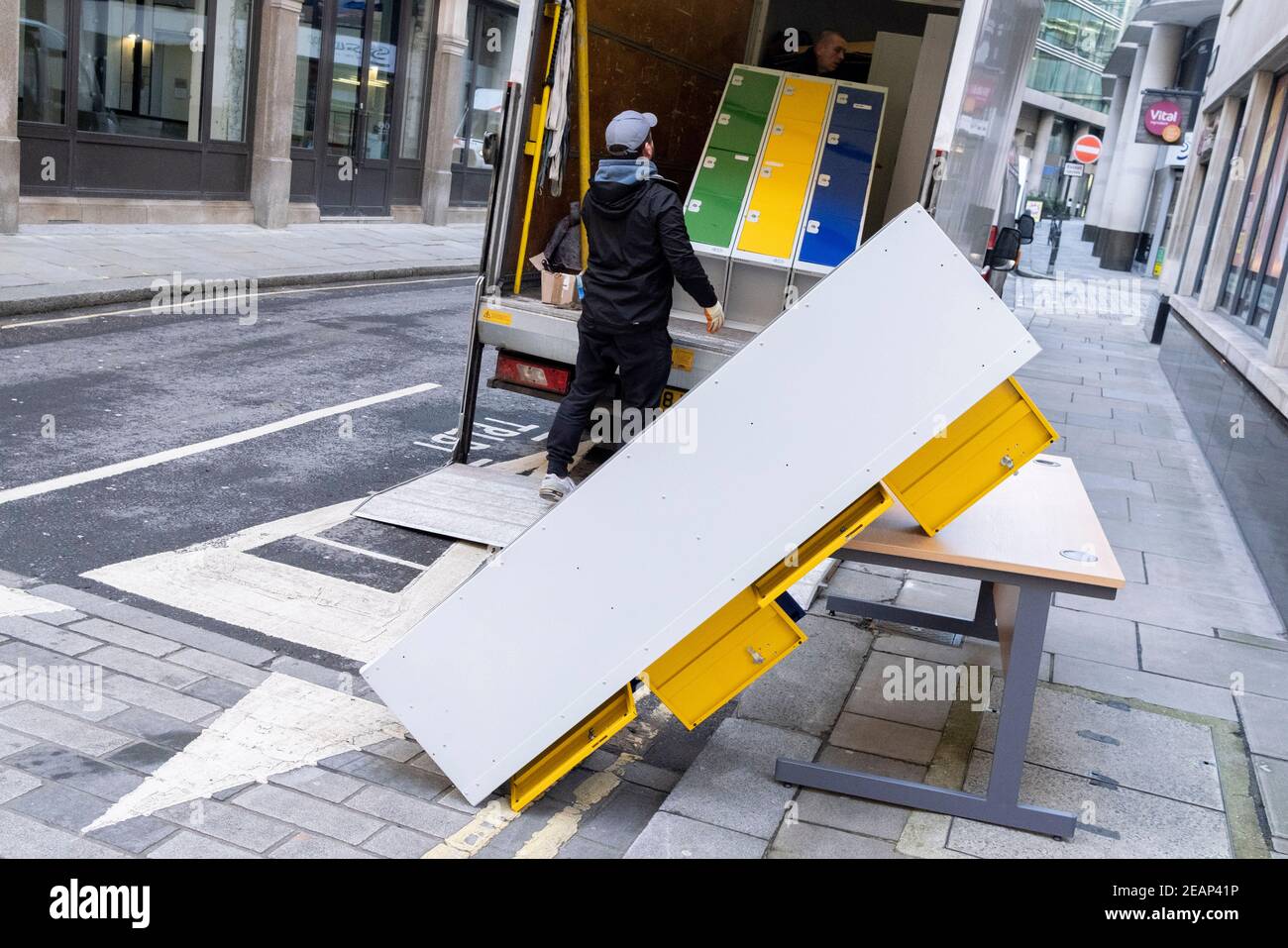 A contractor struggles with unstable office locker furniture being
