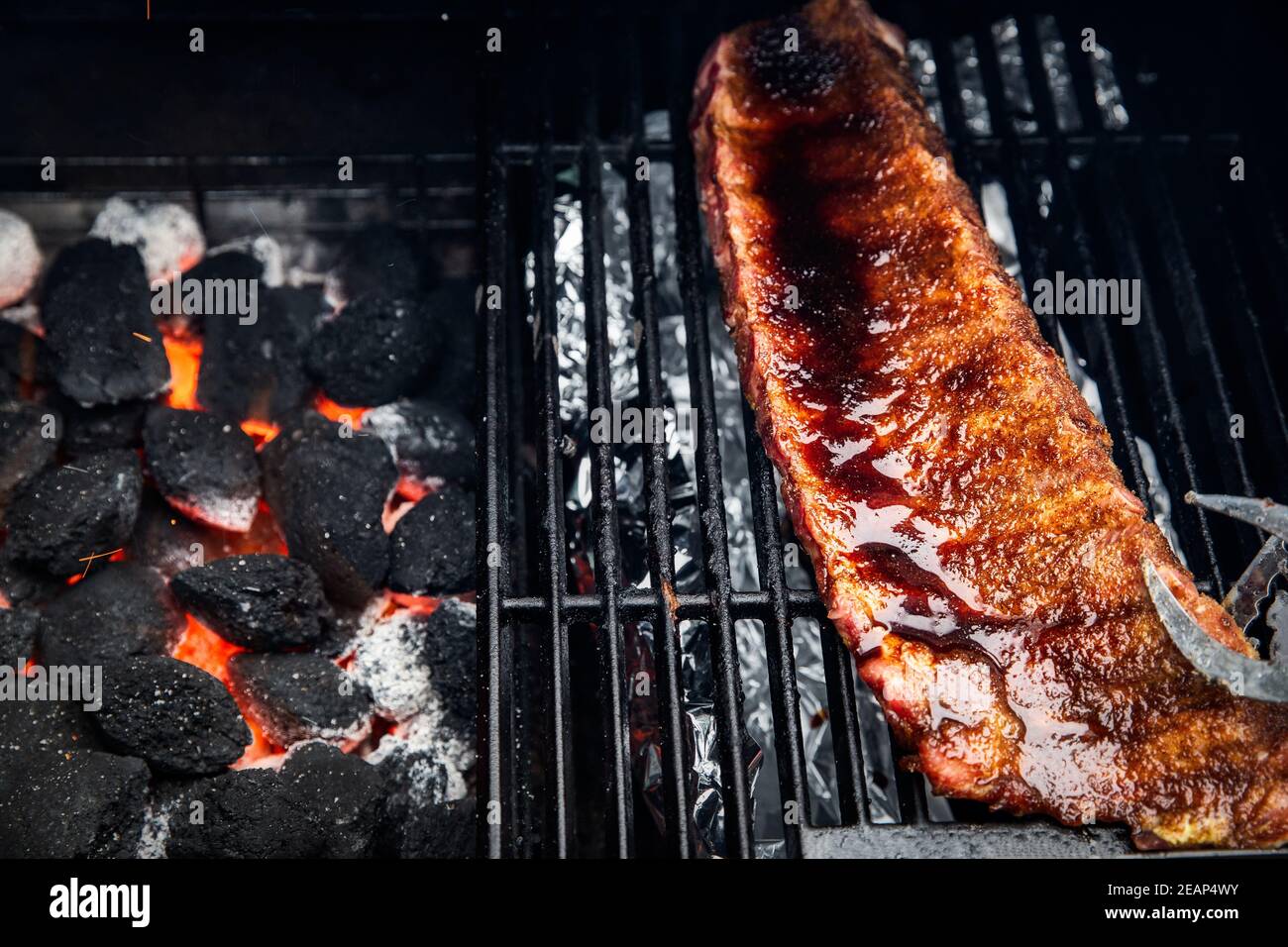 Close-up Of BBQ Roast and Smoked Pork Spareribs glazed with sauze On The  Hot Charcoal Grill With Flames, Barbecue and hobby concept Stock Photo -  Alamy
