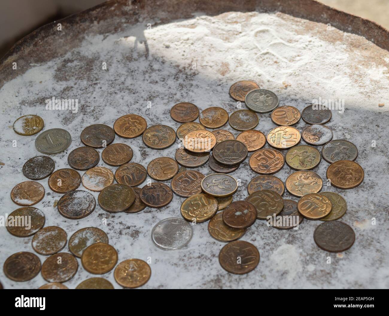 Coins in the flour in the balance. Rubles and kopecks. Stock Photo