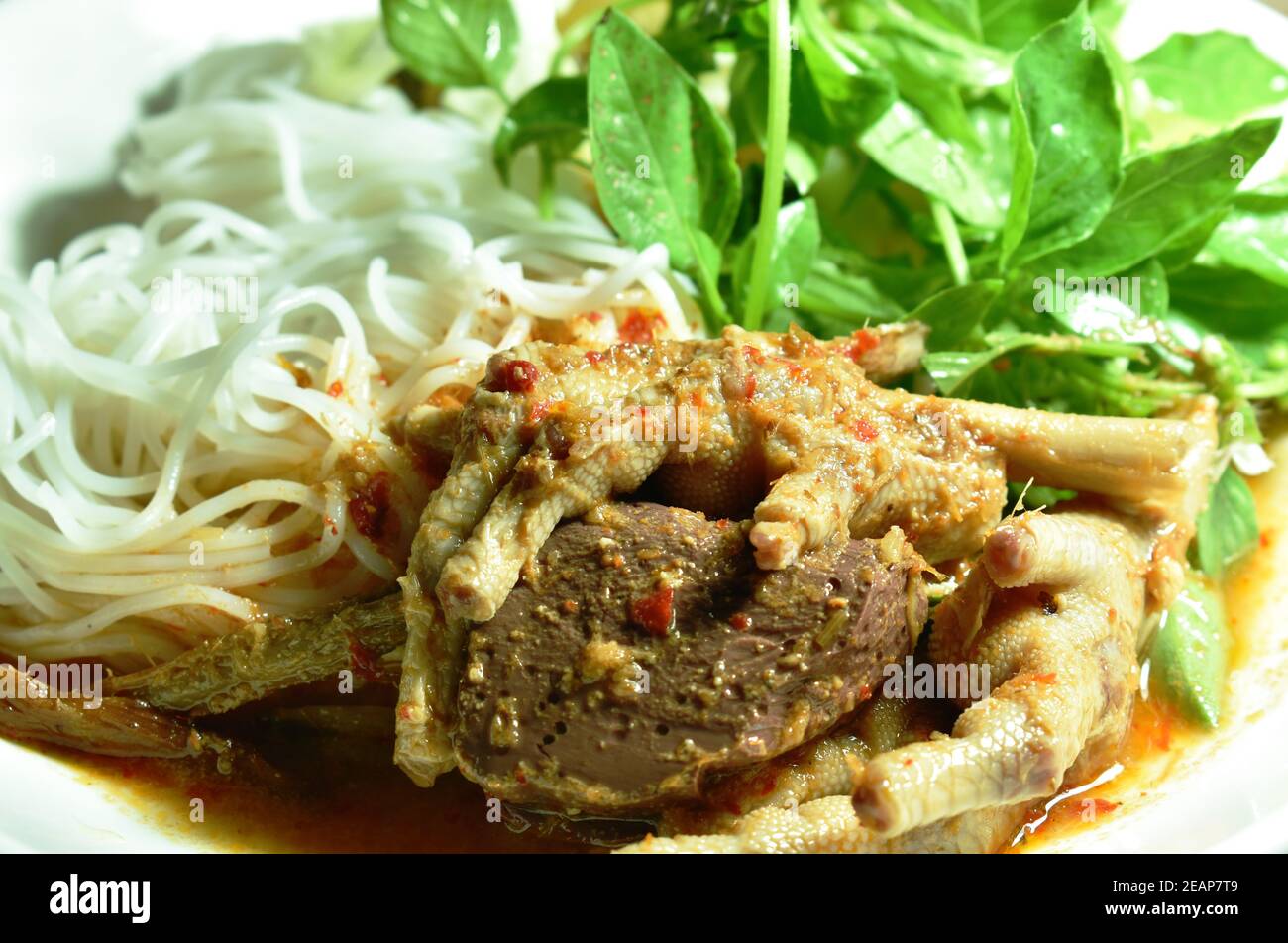 rice noodles dressing with chicken foot and blood curry sauce with
