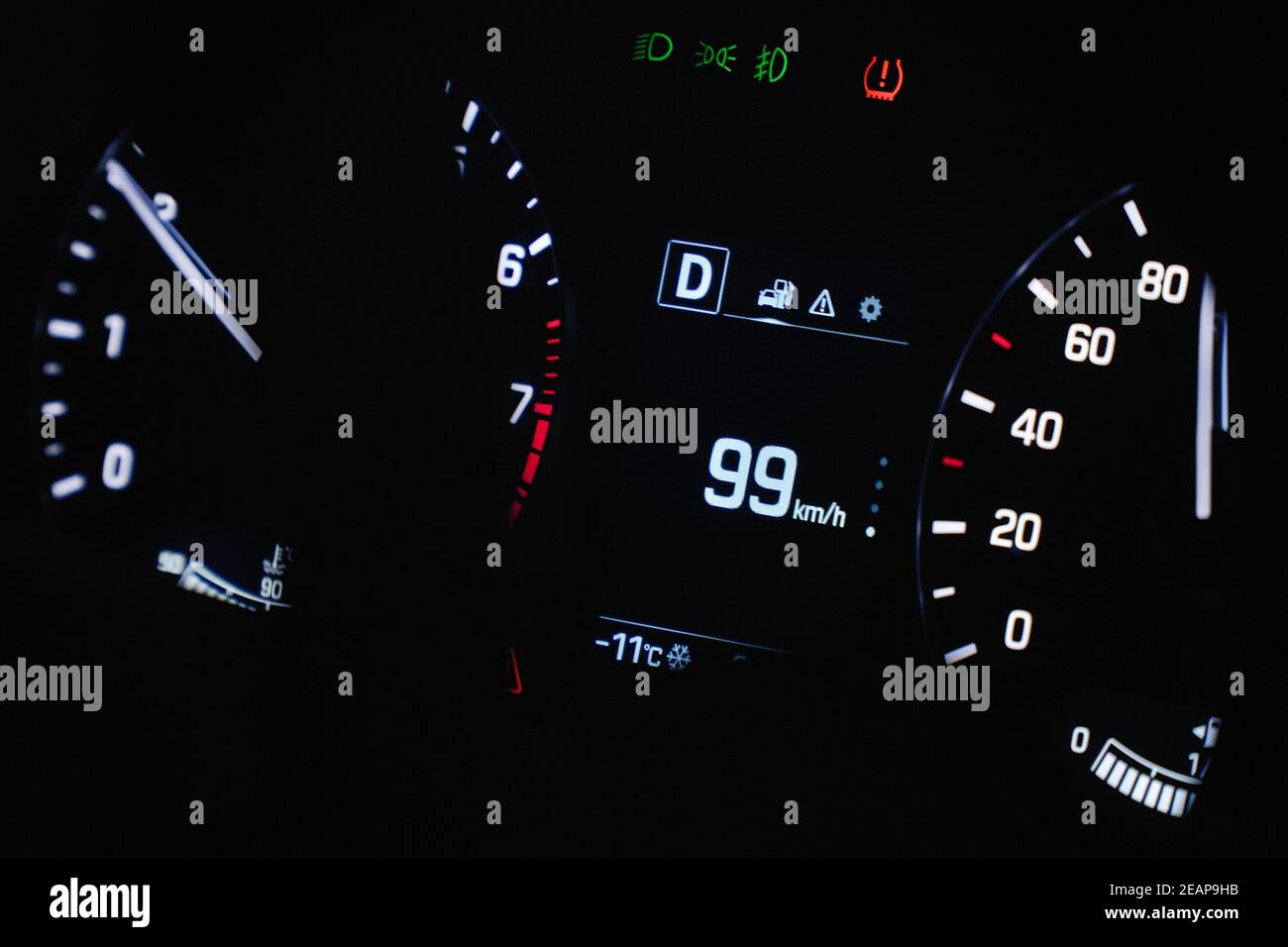 Speedometer in the car on the dashboard. The car's speedometer shows 99