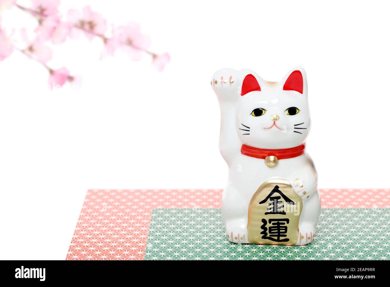 Japanese lucky cat isolated on white background, Japanese word of this photography means 'economic fortune' Stock Photo
