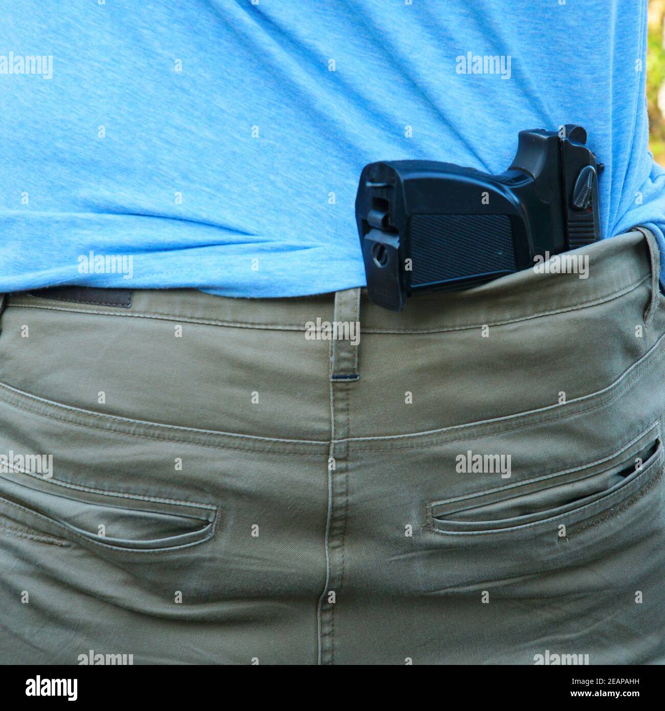 The gun is hidden behind the man's back Stock Photo