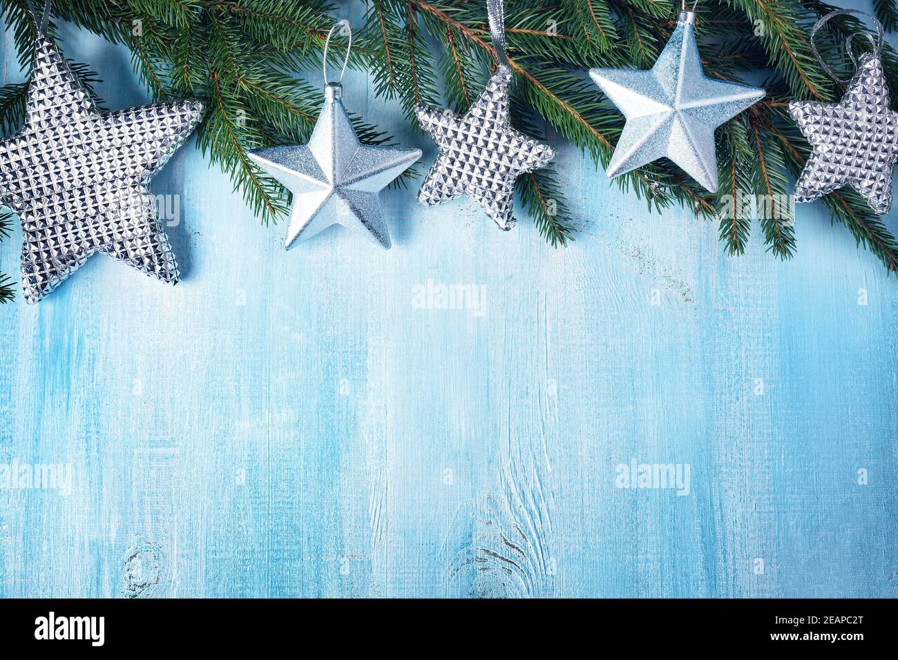 Christmas stars on wooden background with fir tree branches Stock Photo ...