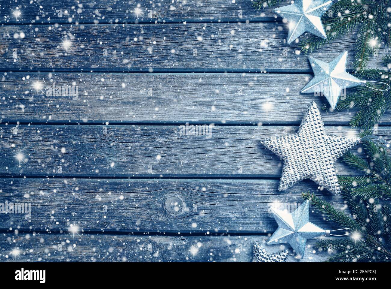Christmas stars on wooden background with fir tree branches Stock Photo ...