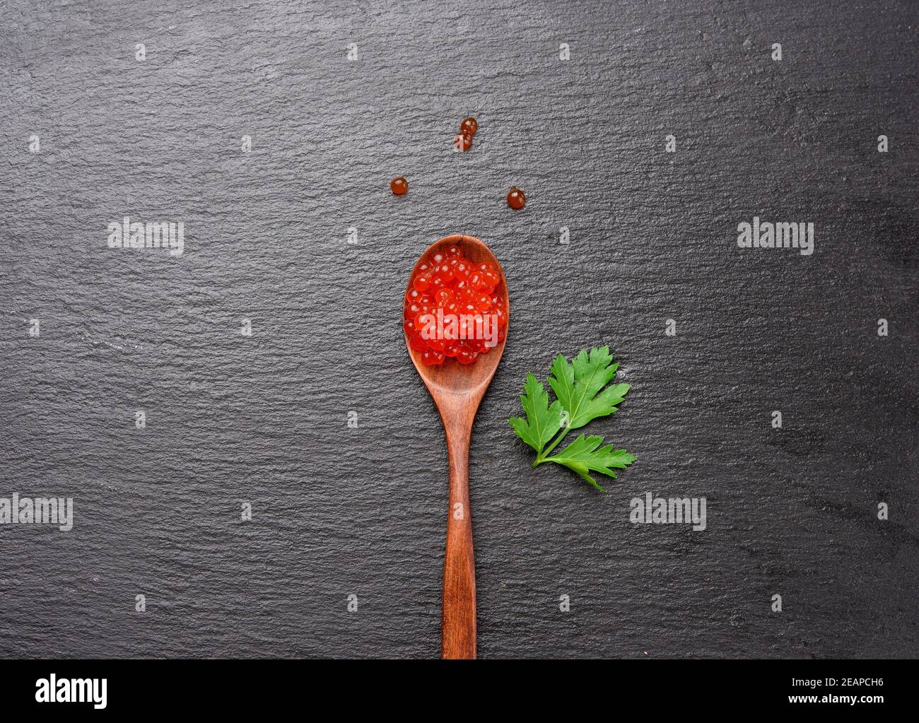 fresh grained red chum salmon caviar in wooden spoon Stock Photo