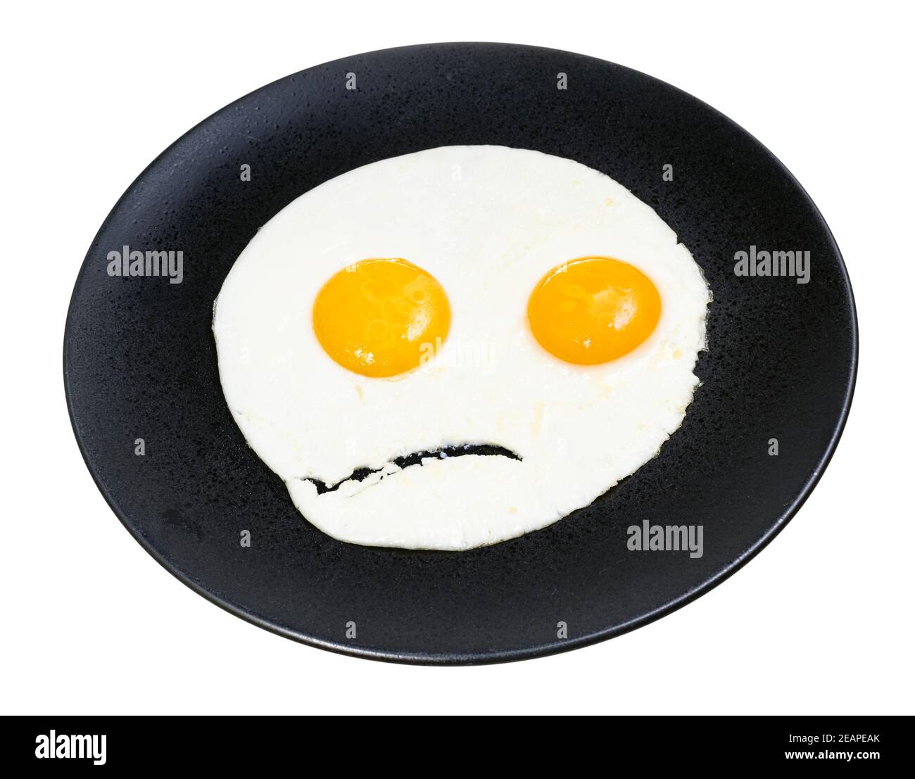 fried eggs on black plate isolated on white Stock Photo