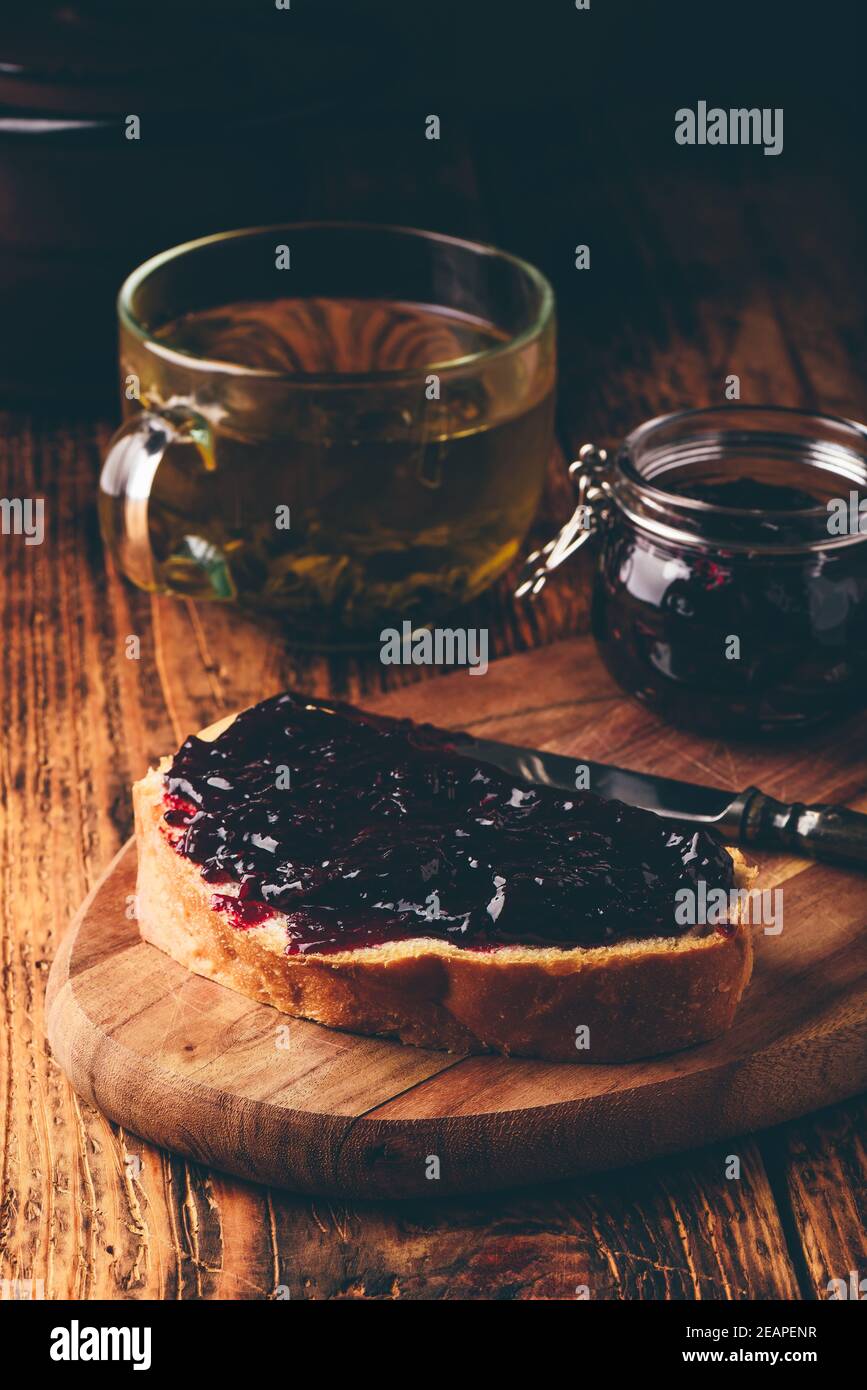Toast with berry jam and green tea Stock Photo Alamy