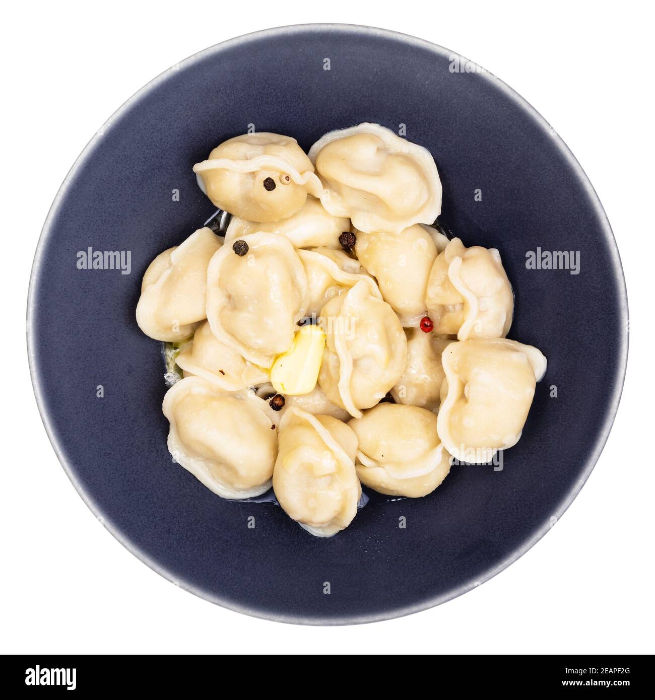 boiled Pelmeni with butter in black bowl isolated Stock Photo