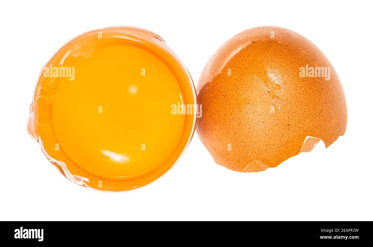 separated egg yolk in shell and brown eggshell Stock Photo