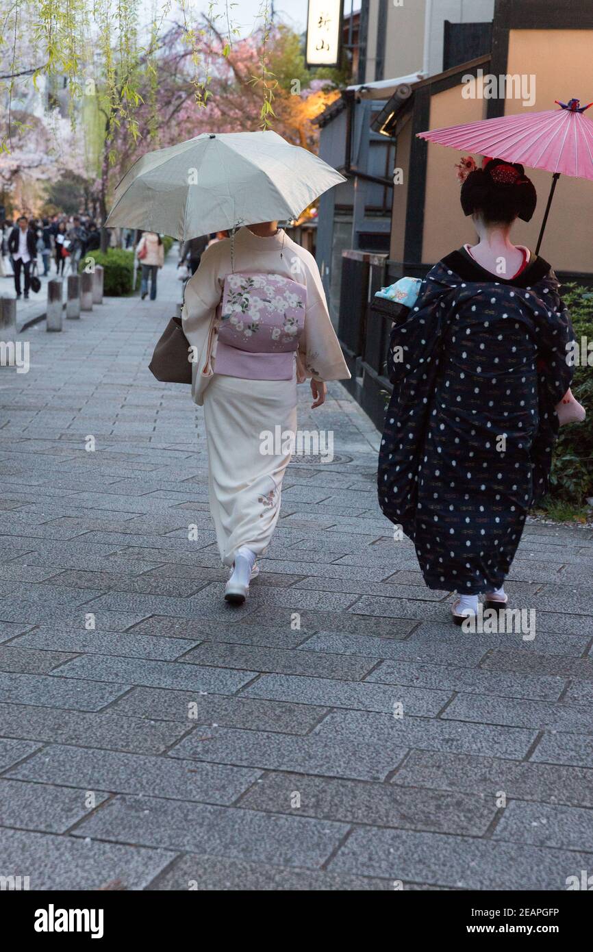 Kyoto Japan Women dressed as geisa walk through Gion District Stock Photo