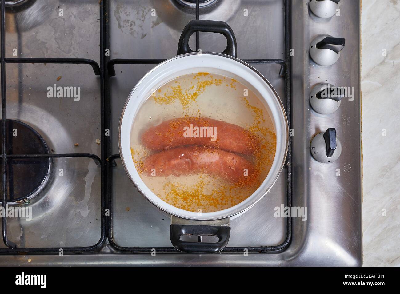 Boiling sausages on stove Stock Photo Alamy