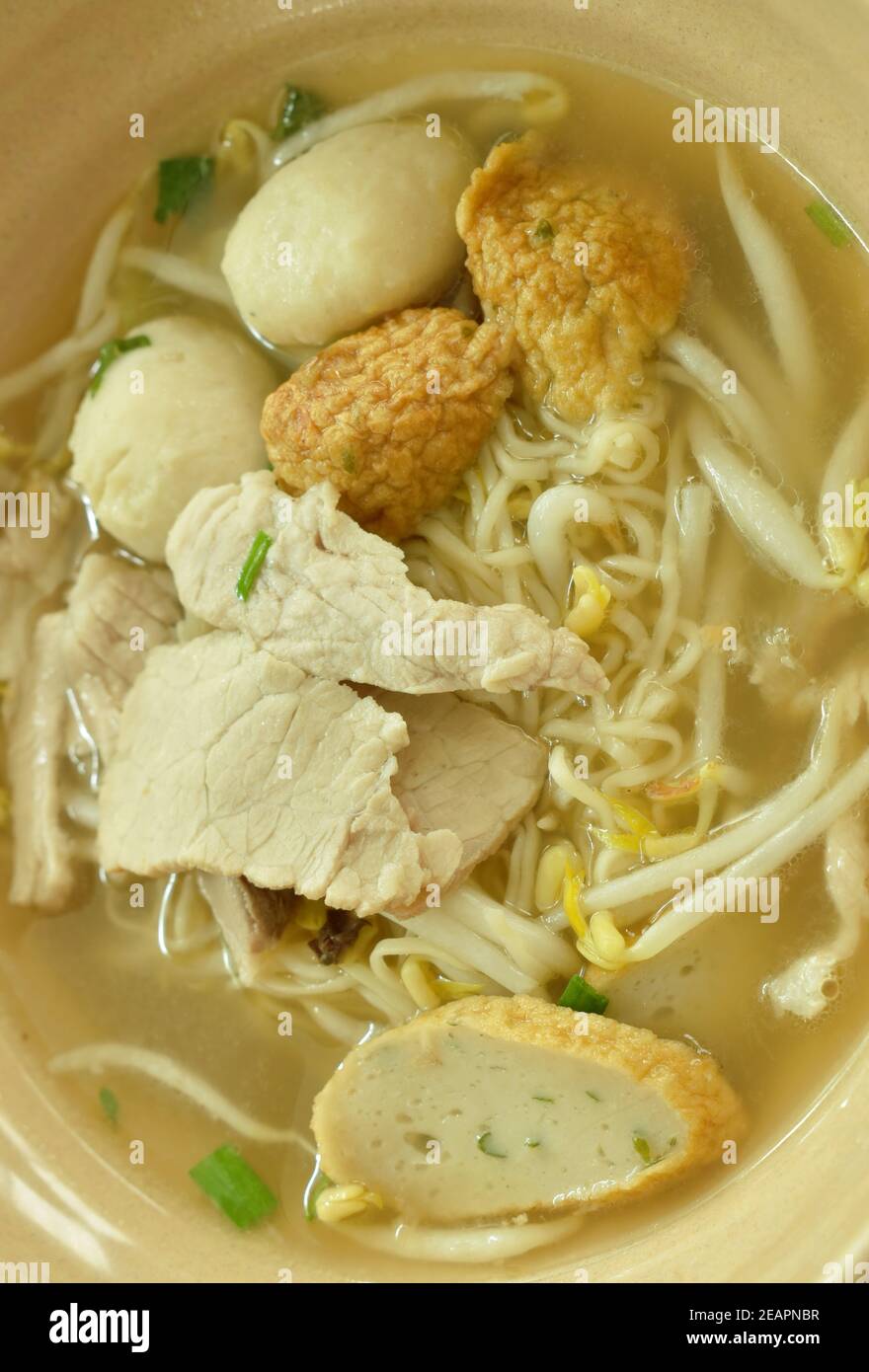 Chinese egg yellow noodles topping slice boiled pork and ball with soup