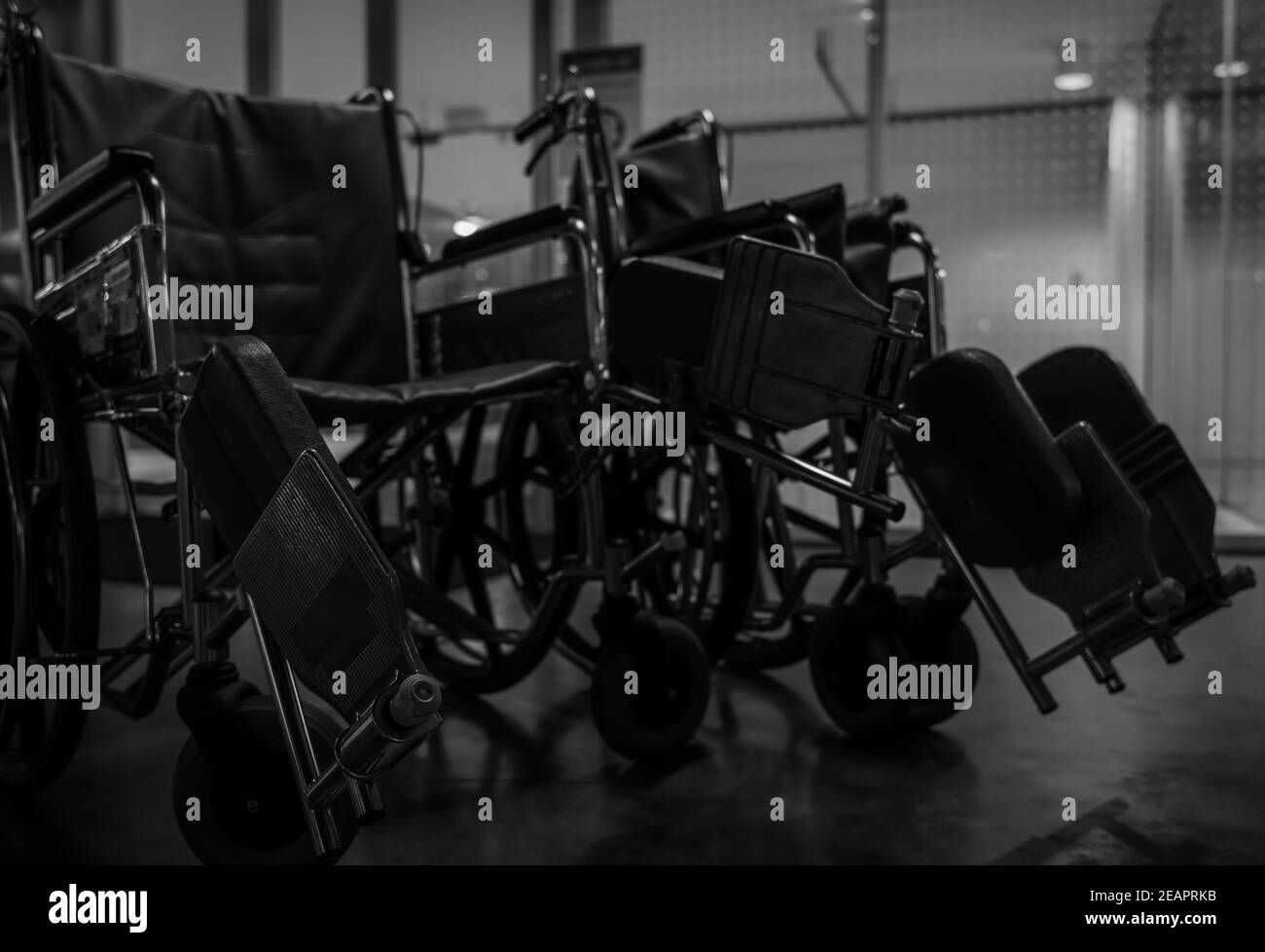 Empty wheelchair in hospital at night for service patient and disabled people. Medical equipment in hospital for assistance handicapped old people. Chair with wheels for patient care in nursing home. Stock Photo
