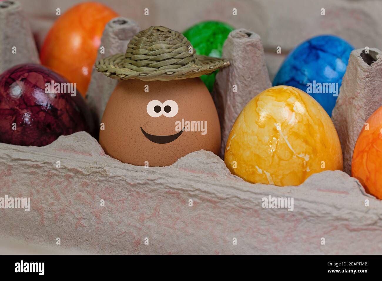 Egg with a funny face in the packaging Stock Photo