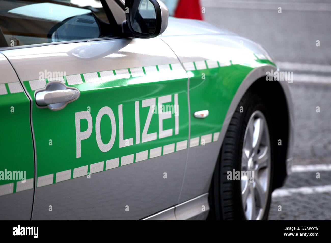Silver police patrol car with green sticker Stock Photo