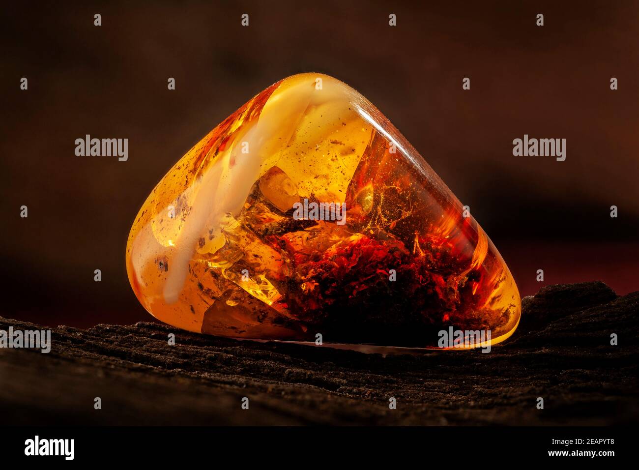 Beauty of natural raw amber. A piece of yellow-red transparent natural