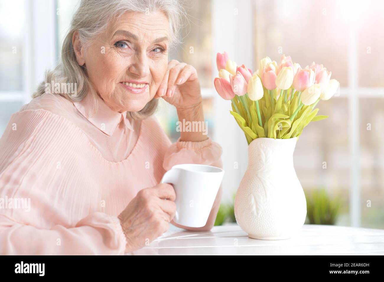 Portrait of beautiful smiling senior woman drinking tea Stock Photo - Alamy