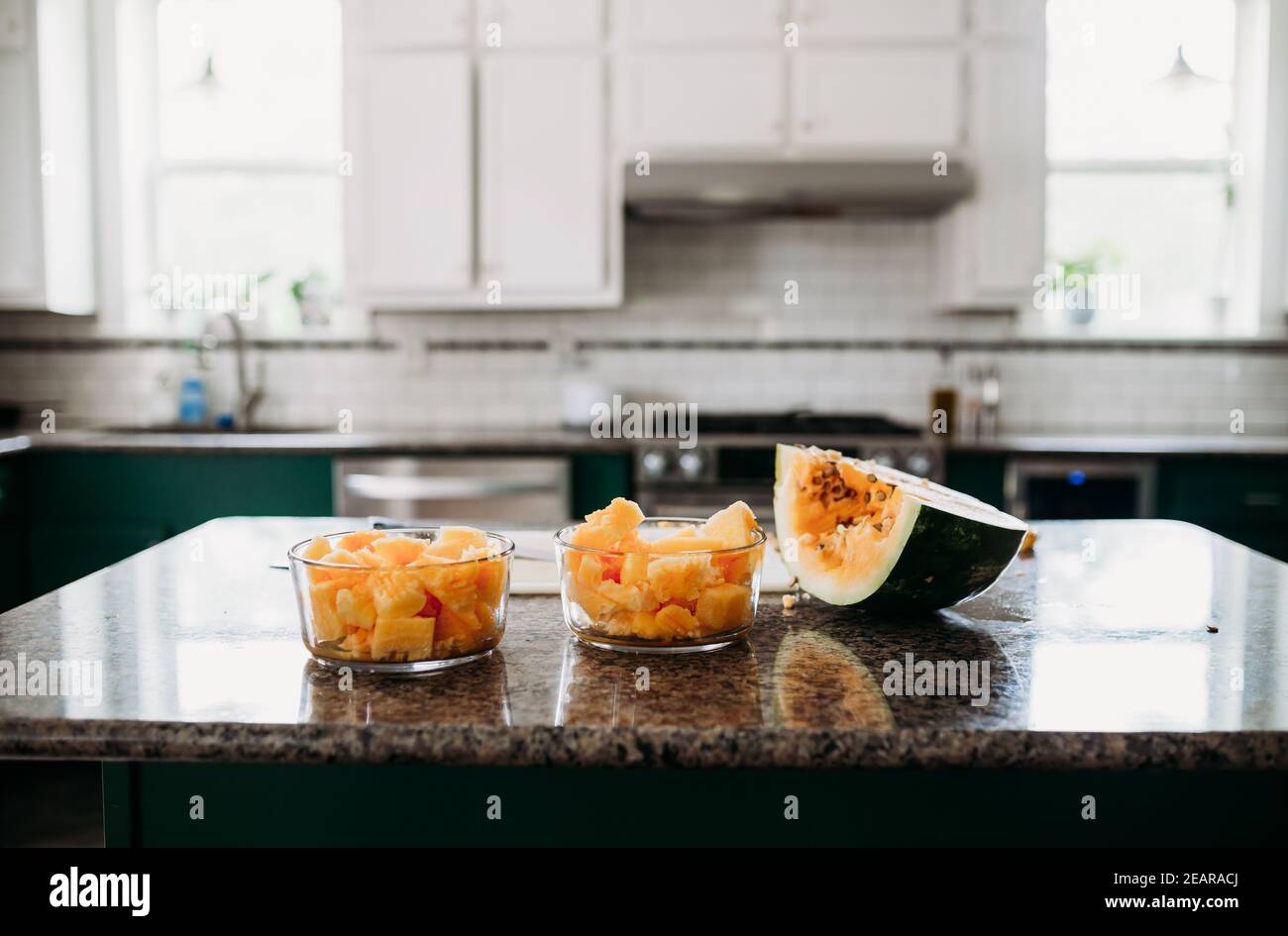 Fresh cut organic orange meat watermelon on counter in modern kitchen