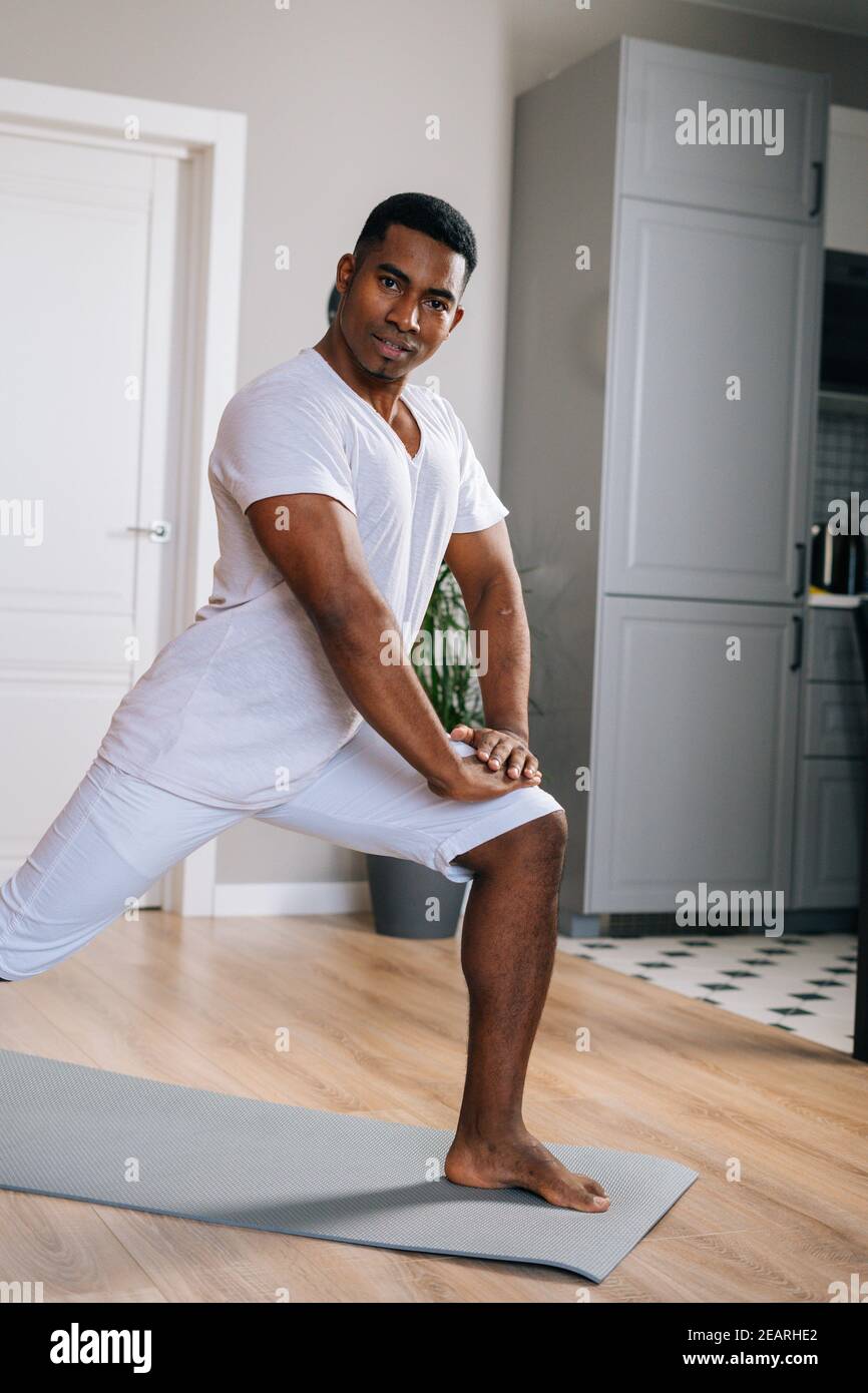 Happy african sportsman stretching hi-res stock photography and images ...