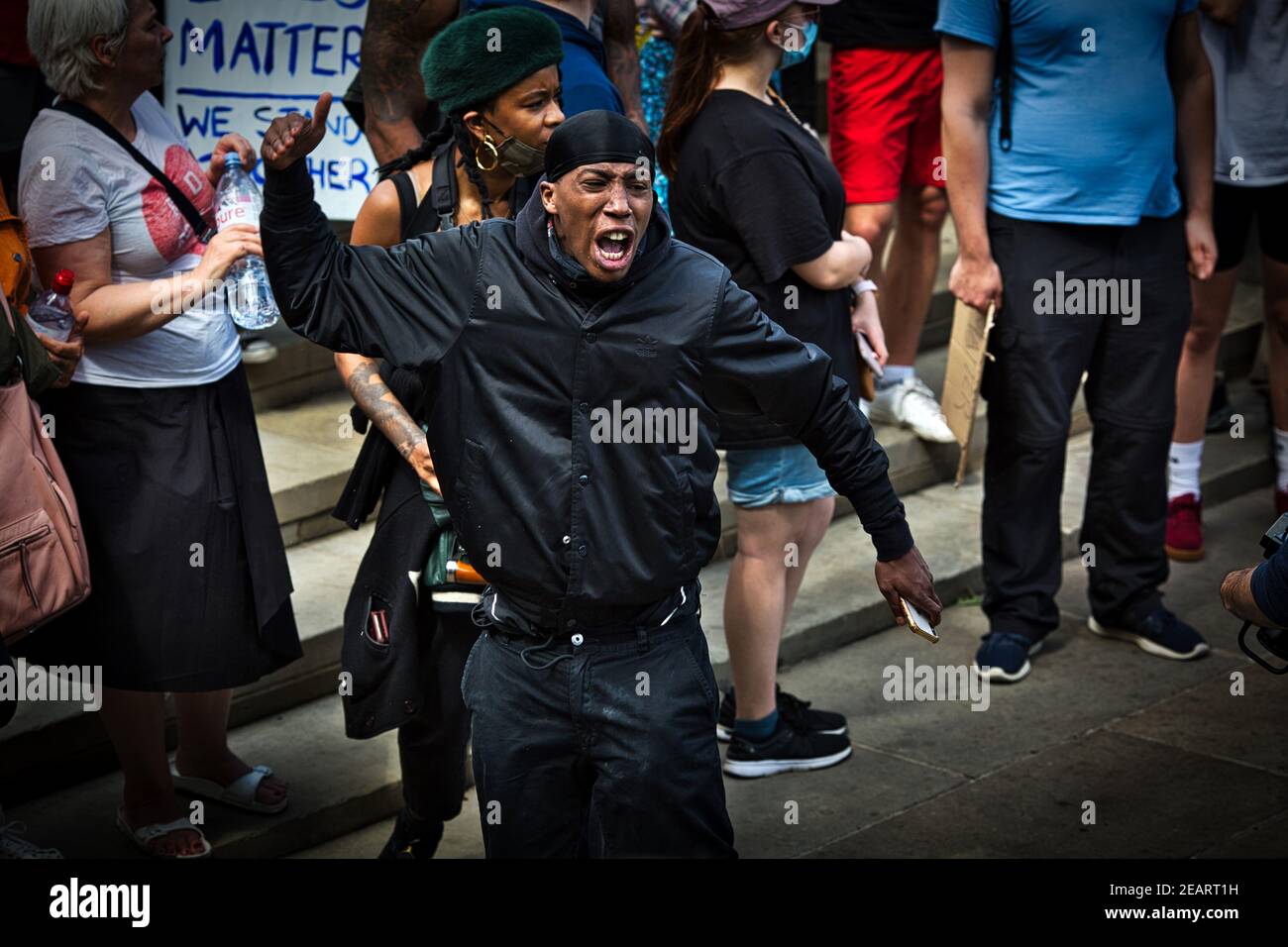 England / London / Supporters of the London Black Revs protest group raise fist to far-right demonstrators in Trafalgar square in London. Stock Photo